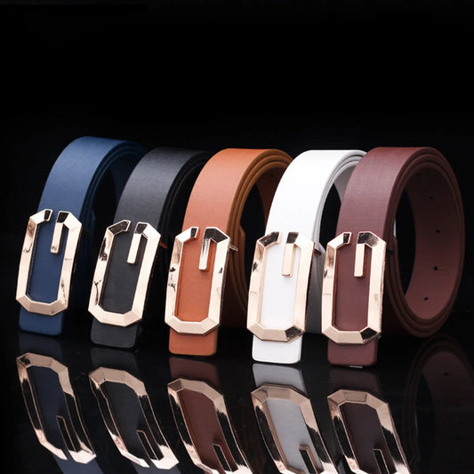 Five leather belts with gold buckles on a reflective black surface