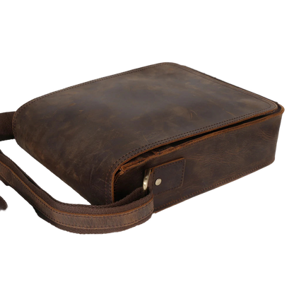 Brown leather crossbody bag with visible 'DUJIANG' branding on a white background