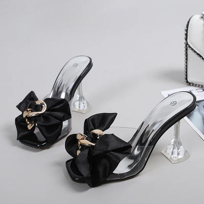 Black high-heeled shoes with bow details