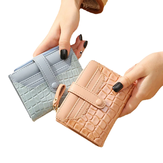 Two_wallets_one_light_blue_and_one_beige_with_crocodile_texture_held_by_a_hand