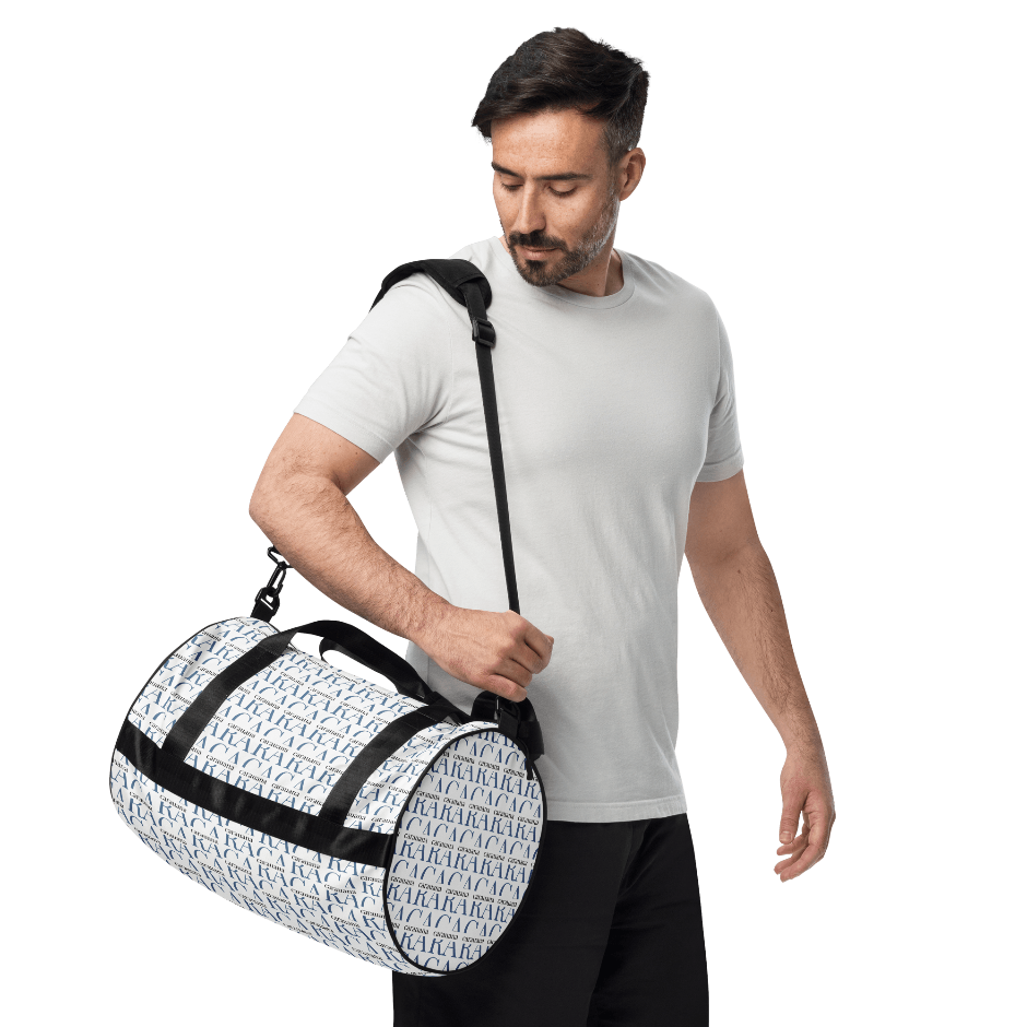 Man holding a white duffel bag with black patterns on a white background