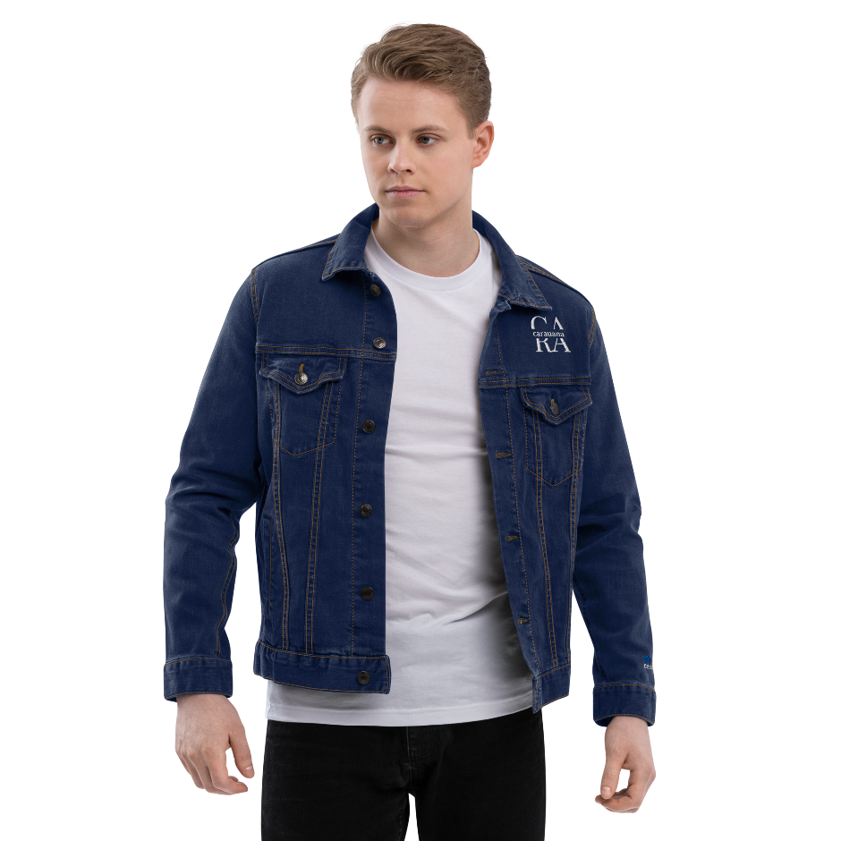 Man wearing a blue denim jacket over a white shirt on a white background