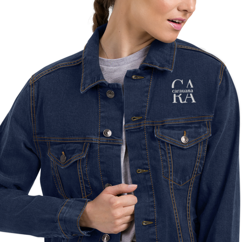 Person wearing a blue denim jacket with a visible brand logo on a white background